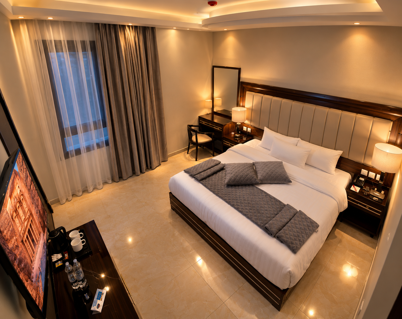 Double room with king bed and warm stone textures